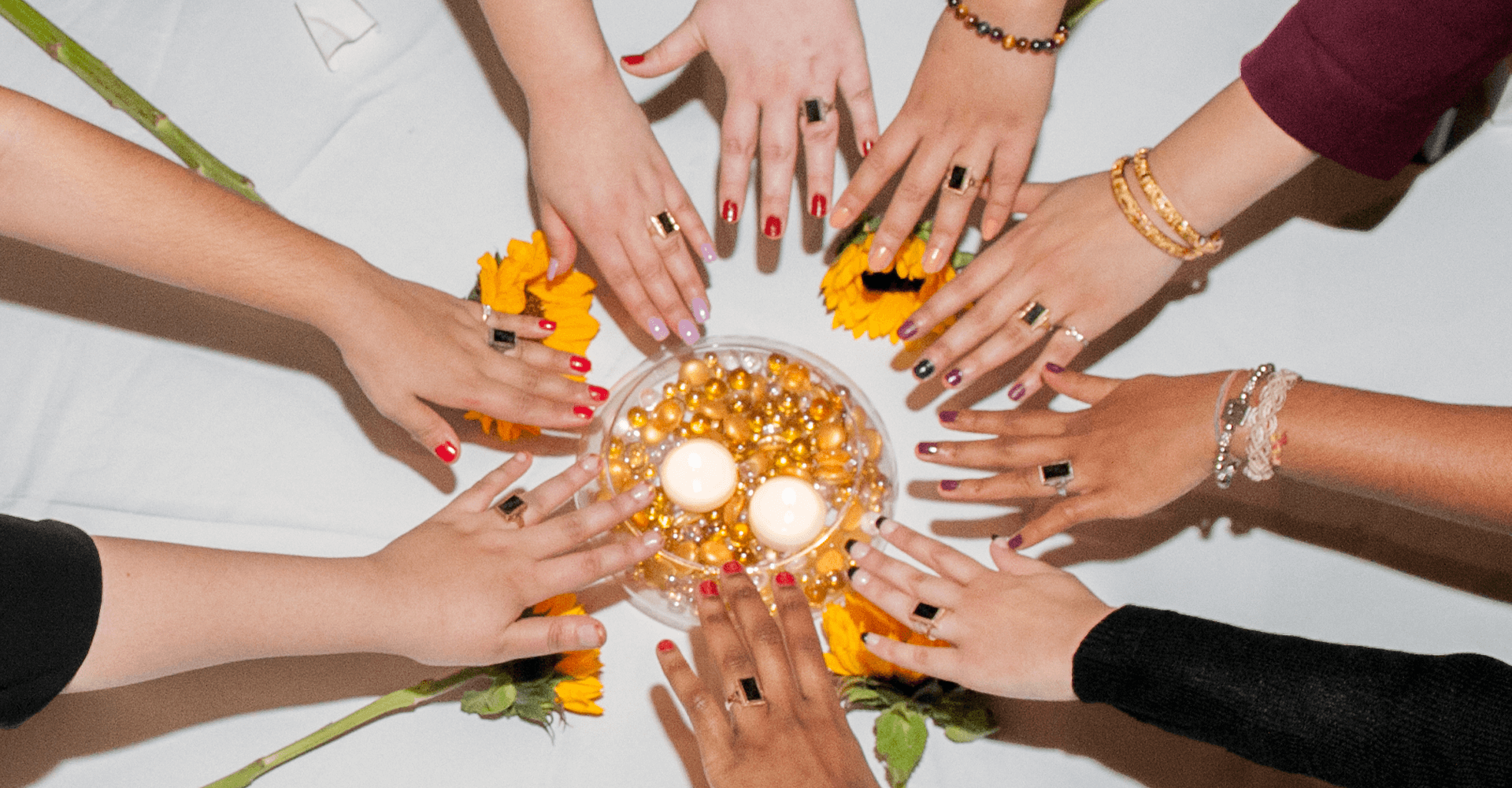 a circle of hands with rings on them